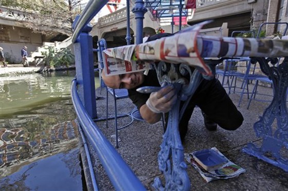 Joseph Chavarria paints the table at the Republic of Texas Restaurant along the River Walk in San Antonio.